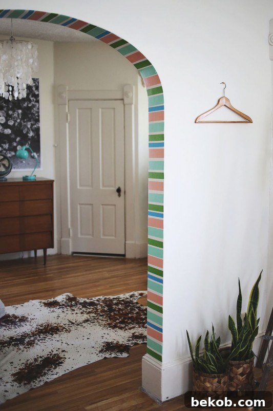 Vibrant Washi Tape Archway Decor by A Beautiful Mess, featuring colorful tape on a doorway arch