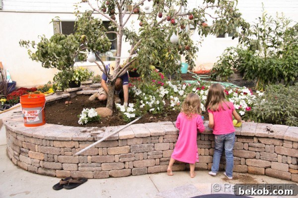 Our daughter helping with garden preparation, digging in the soil for new fall flower plantings