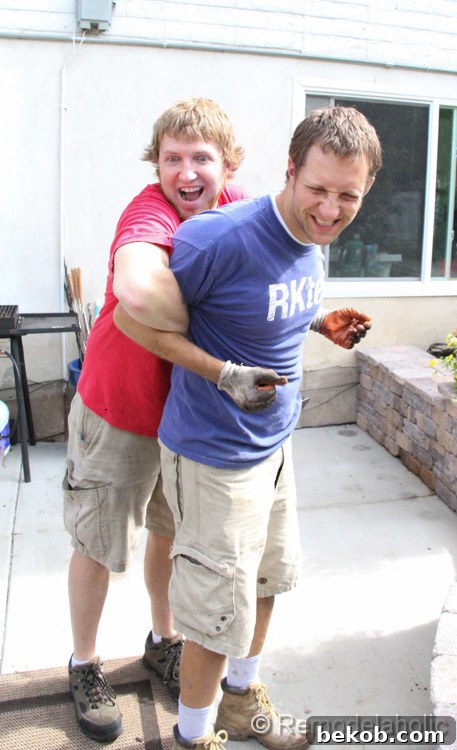 Justin and his brother Josh actively planting a large number of mums and other fall flowers in the garden bed