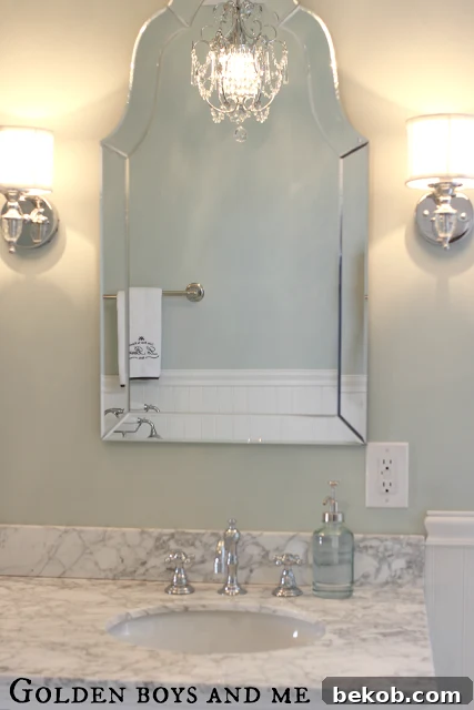 Gorgeous shaped mirror in an elegant master bath