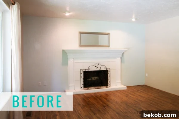 Jordan House Fireplace Remodel Before: Dated White Fireplace with Raised Hearth