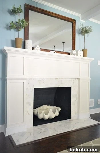 Refaced Brick Fireplace to White Marble with Wood Trim Molding Mantel by Young House Love