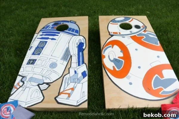 Frugal DIY Wall Decor for Grand Spaces 7 Large DIY Wall Decor for Patio: custom painted cornhole boards painted with Star Wars droids BB-8 and R2-D2, on the grass in a backyard