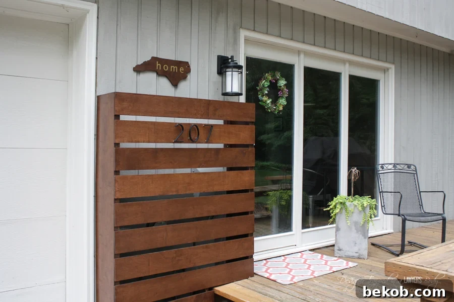 Hide those ugly utility boxes on your house with this gorgeous DIY wood screen. Full tutorial by Designer Trapped in a Lawyer's Body for Remodelaholic.com! This custom wood screen effectively covers up utility boxes, enhancing your home's curb appeal while remaining easily removable for maintenance or meter readings.