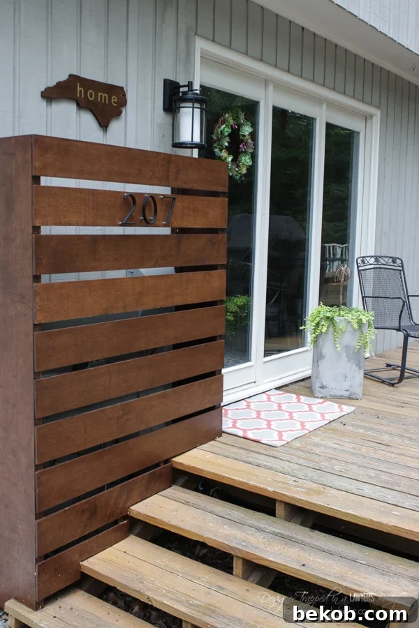 Hide those ugly utility boxes on your house with this gorgeous wood screen DIY utility box cover. Easy to customize, and easy to remove to read the meters or for utility maintenance. The final result shows address numbers added for a personalized touch.