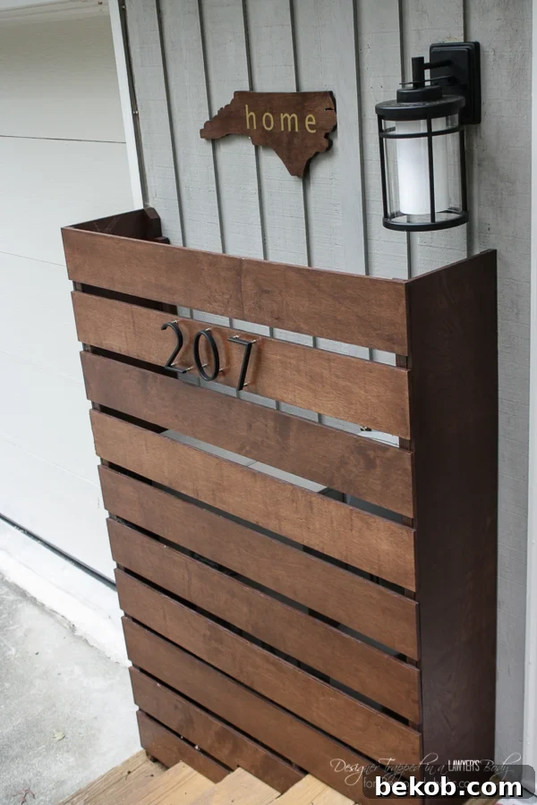 Hide those ugly utility boxes on your house with this gorgeous wood screen DIY utility box cover. Easy to customize, and easy to remove to read the meters or for utility maintenance. This final shot highlights the overall curb appeal improvement.