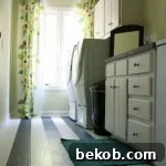 low-cost-laundry-room-makeover-featured-on-Remodelaholic. An image showcasing a beautifully organized and renovated laundry room, achieved on a budget.