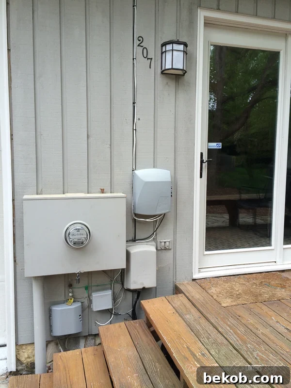 (Before) Hide those ugly utility boxes on your house with this gorgeous wood screen DIY utility box cover. This before image emphasizes the need for a solution that is easy to customize and remove for utility access, showcasing the initial unsightly appearance.