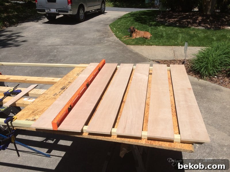 diy-wood-screen-1: Close-up of cutting front slats for the DIY utility box cover, showing precision and attention to detail for a custom fit, especially around stairs.