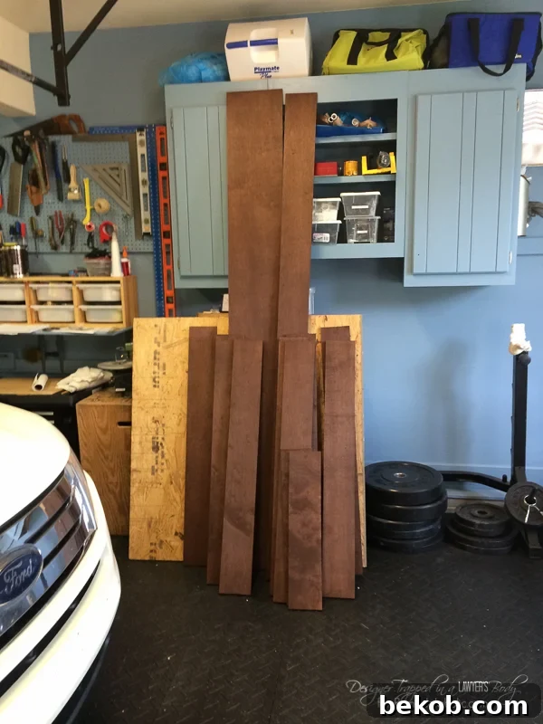 DIY Utility Box Cover - Wood Screen for the Side of the House Eyesores. This image displays the stained and sealed wood pieces laid out, ready for assembly, highlighting the importance of weather protection.