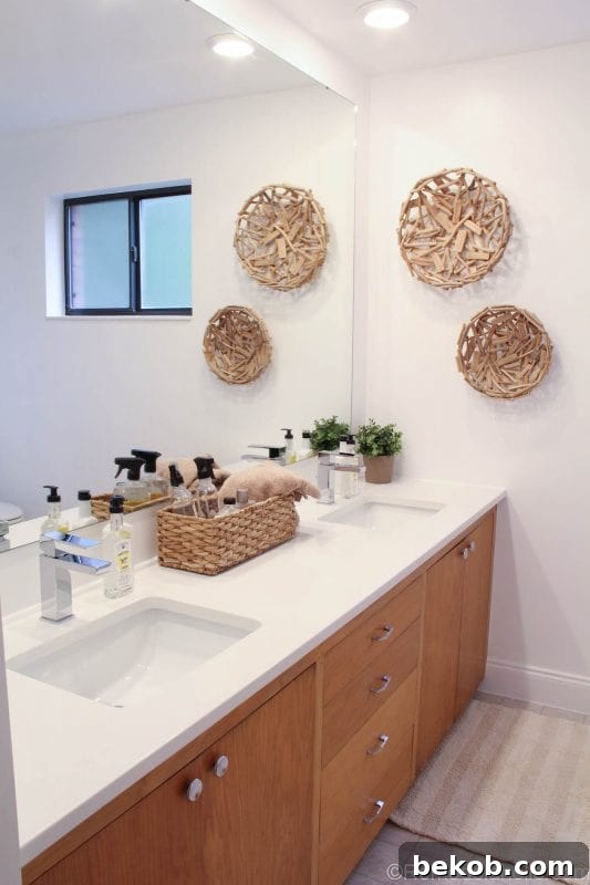 Overall view of modern bathroom remodel with large mirror