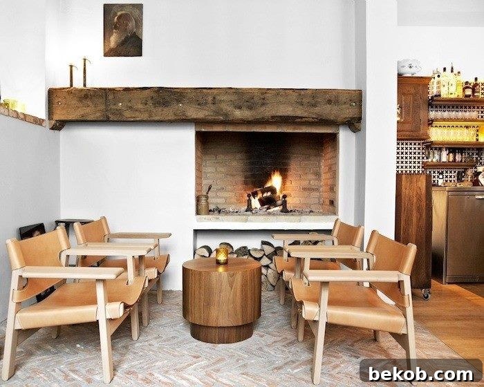 Rustic charm of an off-center fireplace with exposed brick, weathered beam, and cozy seating