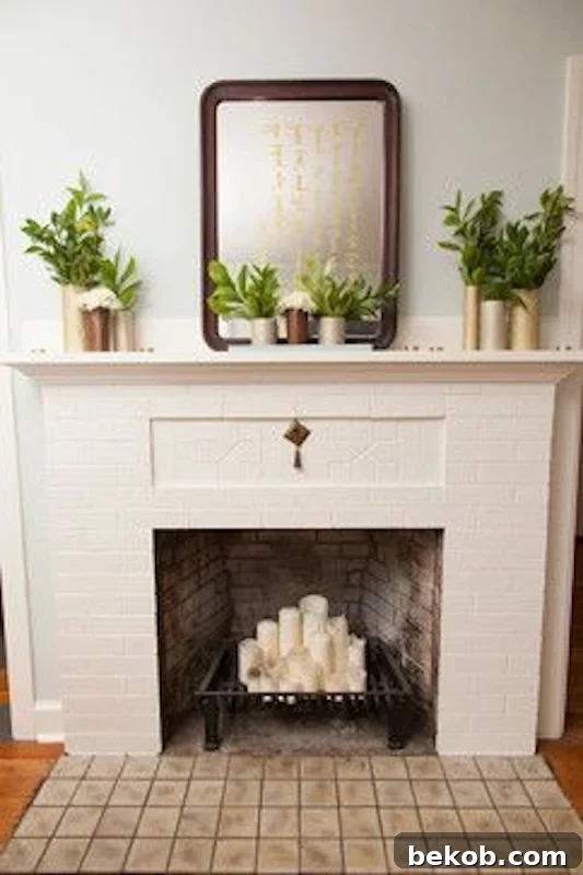 Classic and understated fireplace mantel with vintage mirror, plants, and candles