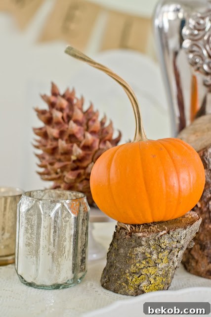 Stunning Pumpkin Centerpieces: Elevate Your Fall Table 19 Pumpkin centerpiece on cut branch