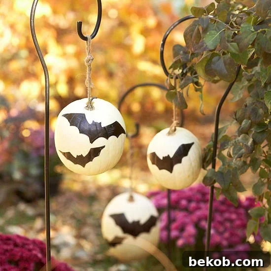 Stunning Pumpkin Centerpieces: Elevate Your Fall Table 26 Hang pumpkins from plant holders