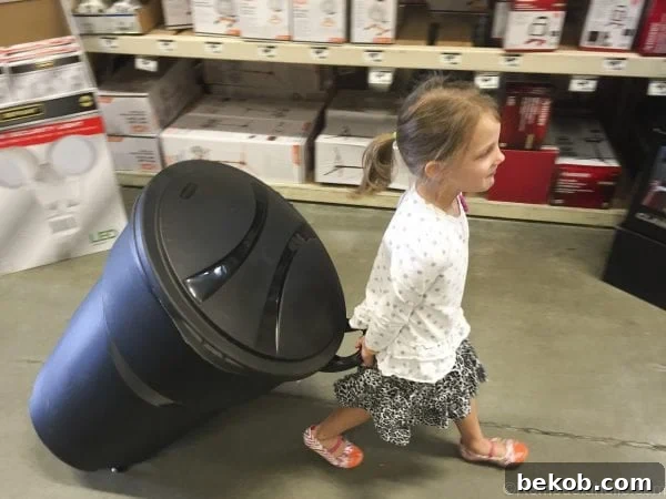 Lydia proudly wheeling the new Rubbermaid Roughneck trash can