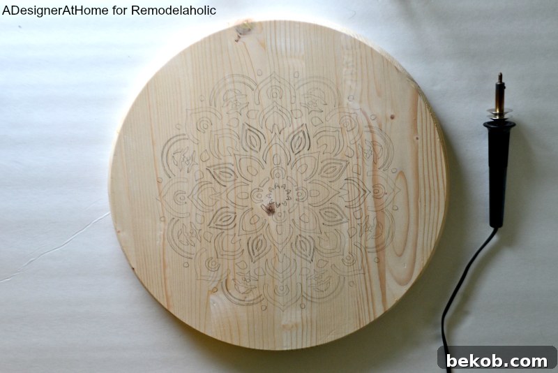 Pencil-stenciled mandala design on a precut wood circle with a wood-burning tool
