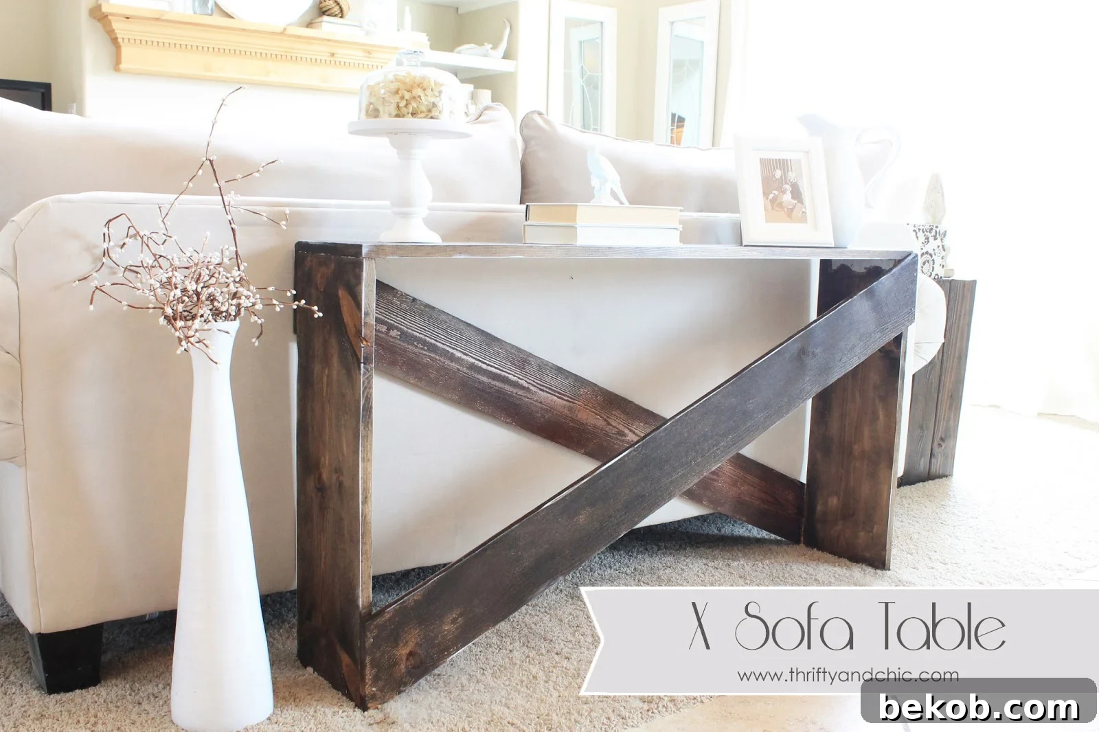 Simple DIY X-leg sofa table behind a couch, offering practical surface space.