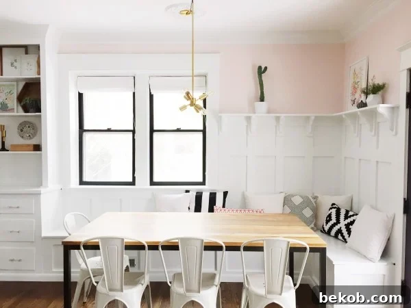 Evolving Dining Spaces Banquette Style 3 After photo of a gorgeously renovated dining room featuring a built-in banquette, wainscoting, and a custom hutch, painted in a sophisticated navy hue.
