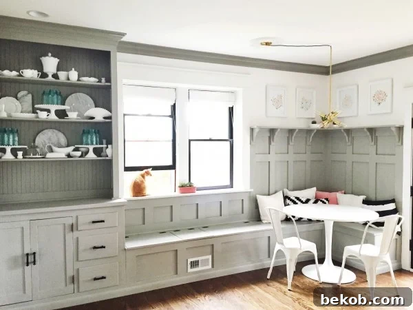 Evolving Dining Spaces Banquette Style 6 Elegant grey dining room banquette and built-in hutch with detailed board and batten paneling.