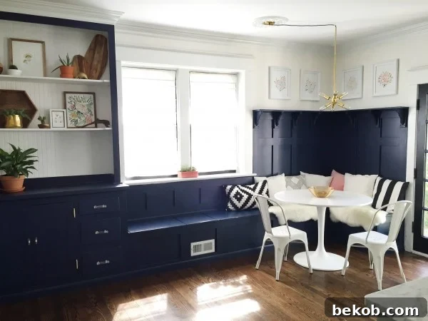 Evolving Dining Spaces Banquette Style 7 Sophisticated navy dining room banquette and built-in hutch, complemented by paneled board and batten detailing.