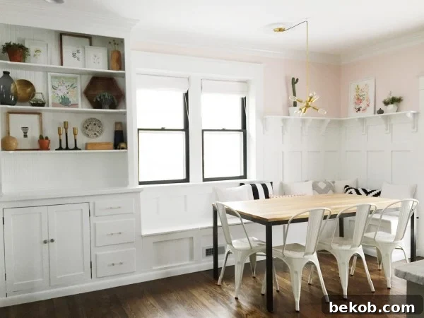 Evolving Dining Spaces Banquette Style 8 Chic pink and white dining room banquette with built-in hutch, featuring elegant board and batten and minimalist decor.