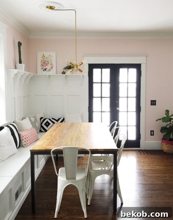 Evolving Dining Spaces Banquette Style 9 View of a modern dining room banquette and built-in hutch, showcasing beautiful wainscoting and sophisticated decor.