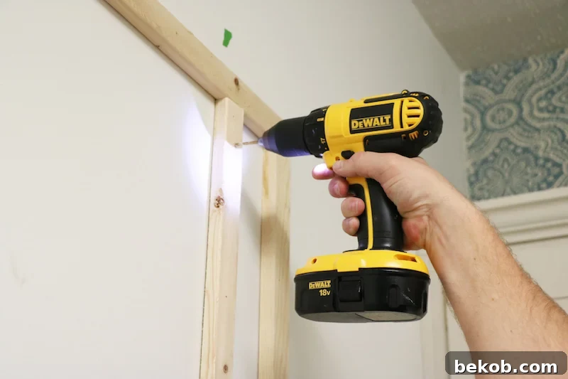 Drilling pilot holes into the pegboard to prevent splitting and ensure smooth screw insertion.