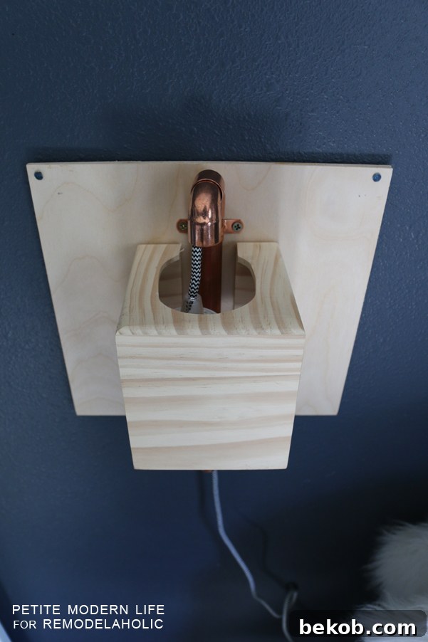 Make this industrial modern, apartment friendly DIY wall sconce with the simplest of materials!