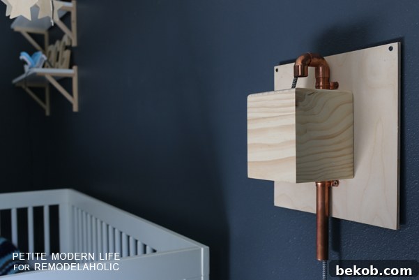 Make this industrial modern, apartment friendly DIY wall sconce with the simplest of materials!