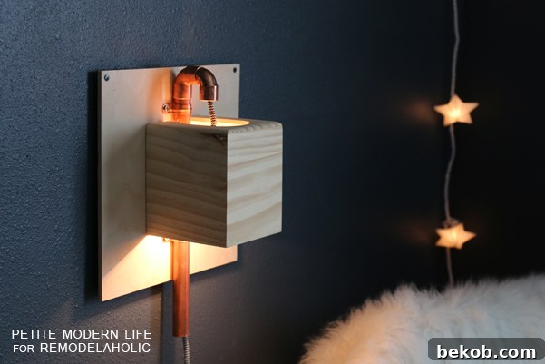 Make this industrial modern, apartment friendly DIY wall sconce with the simplest of materials!
