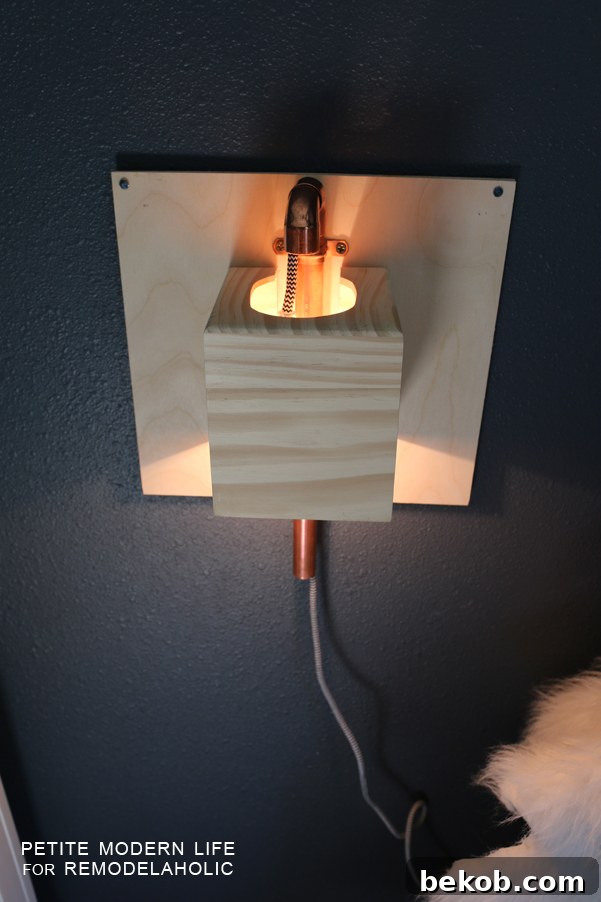 Make this industrial modern, apartment friendly DIY wall sconce with the simplest of materials!