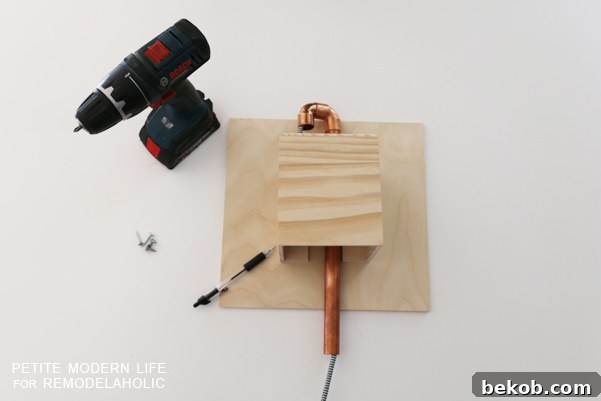 Make this industrial modern, apartment friendly DIY wall sconce with the simplest of materials!