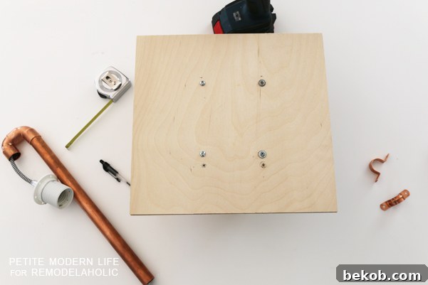 Make this industrial modern, apartment friendly DIY wall sconce with the simplest of materials!