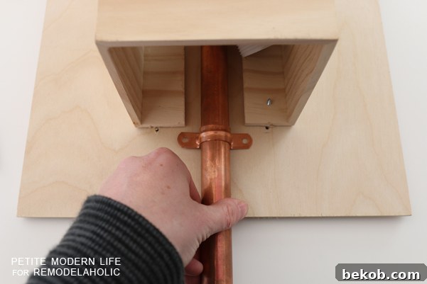 Make this industrial modern, apartment friendly DIY wall sconce with the simplest of materials!