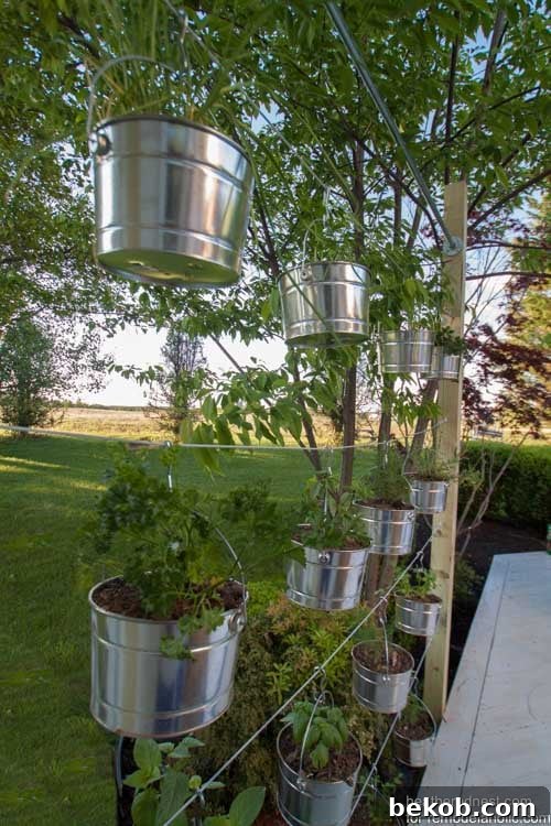 This suspended vertical garden is a great weekend DIY! Perfect for an herb garden or some beautiful flowers, and the kids could plant their own seeds in the lower rows. Tutorial from The Heathered Nest on @Remodelaholic.