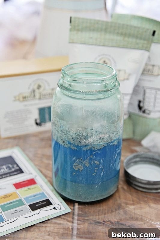 How to use watered down Miss Mustard Seed Milk paint for creating beachy look in a console table by Shabbyfufu featured on @Remodelaholic