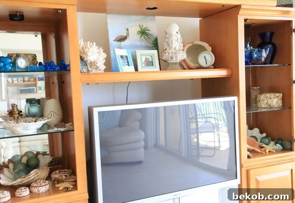 Large entertainment center replaced with DIY Beachy Console Table, by Shabbyfufu featured on @Remodelaholic