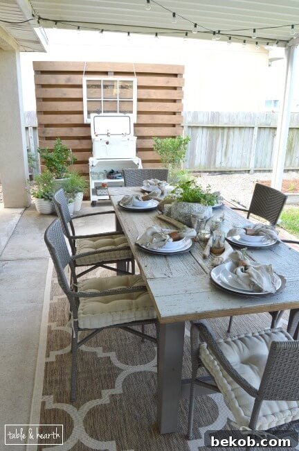 Stunning reclaimed wood farmhouse patio table by Table and Hearth, perfect for outdoor dining and entertaining.