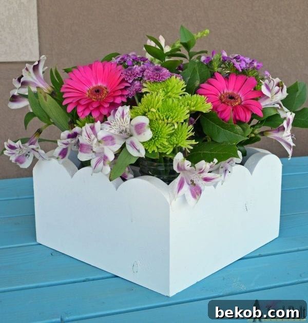 Elegant scalloped mason jar centerpiece with flowers by HerToolBelt