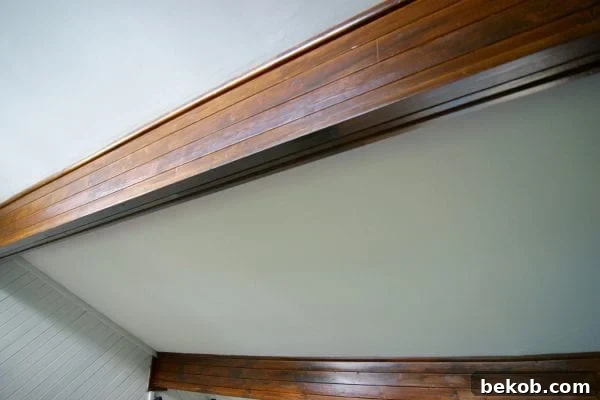 Close-up of gel stained paneled beam showing seams