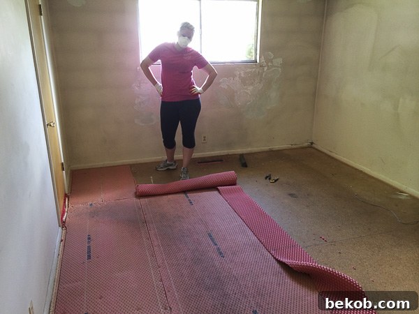 Ultimate Master Bedroom Oasis 3 Red carpet being ripped out of the master bedroom, revealing old subfloor