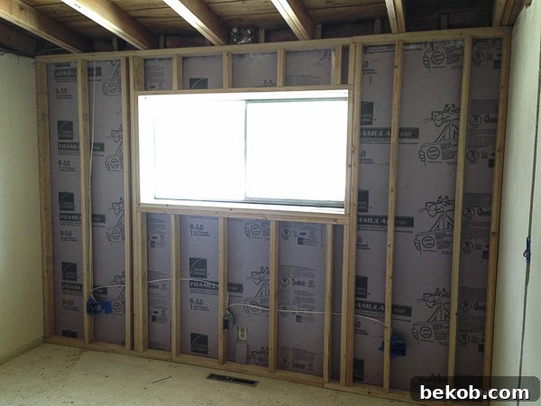 Ultimate Master Bedroom Oasis 5 Master bedroom during insulation and framing, showing exposed cinder blocks and new studs