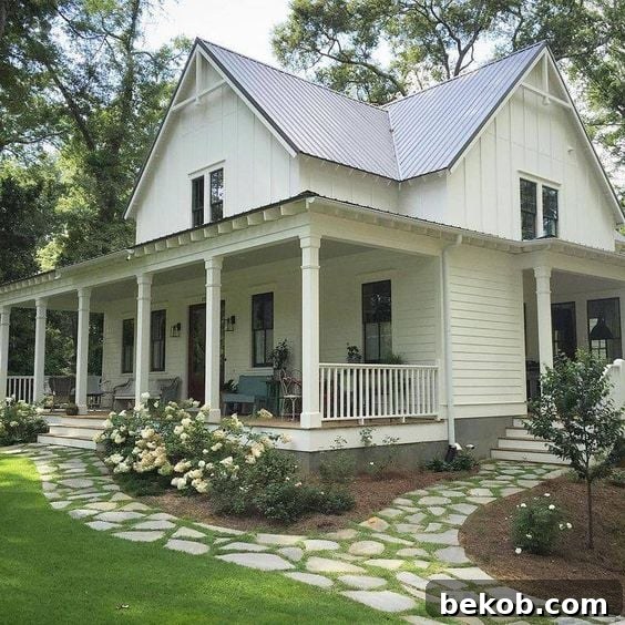Elegant Southern home with inviting front porch, railings, and mature greenery, showcasing refined curb appeal.