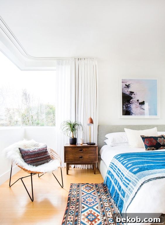 Chic Modern Coastal Bedroom with Crisp Whites and Blue Art