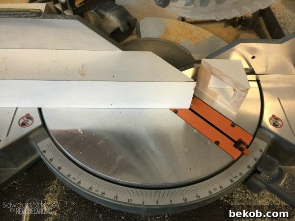 Cutting the ends of the assembled corbels at a 45-degree angle for the finished decorative shape.