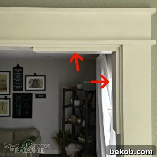 Installing a 1x4 support board directly to the door frame to provide a stable base for the corbel.