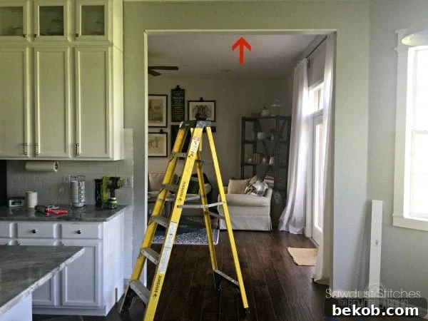 Securing the interior top casing board with a nail gun for a strong, lasting fit.