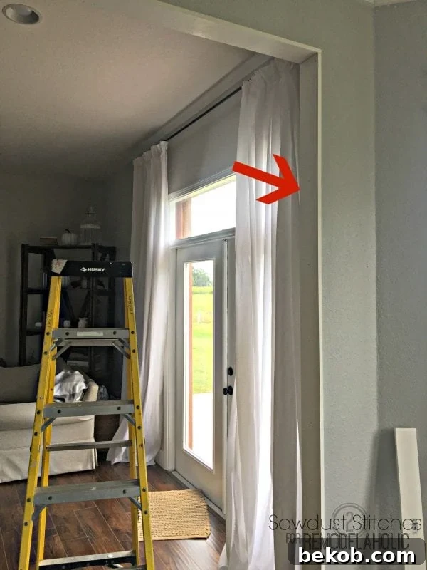 Installing the interior side casing board on a doorway, ensuring a flush fit.