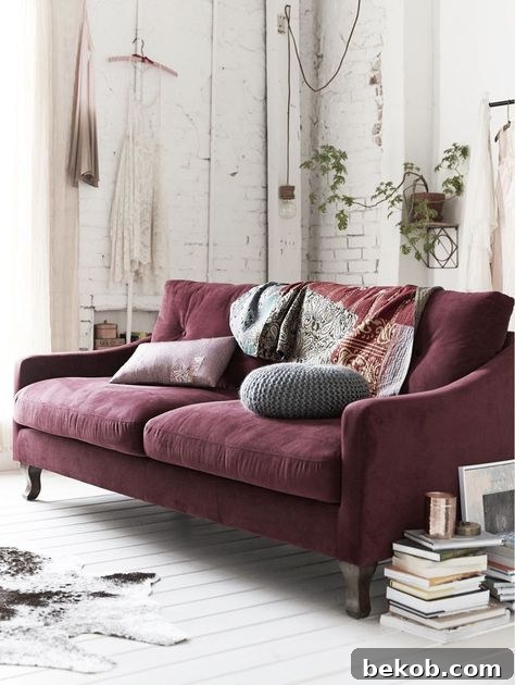 Decorating a neutral living room, with a maroon couch